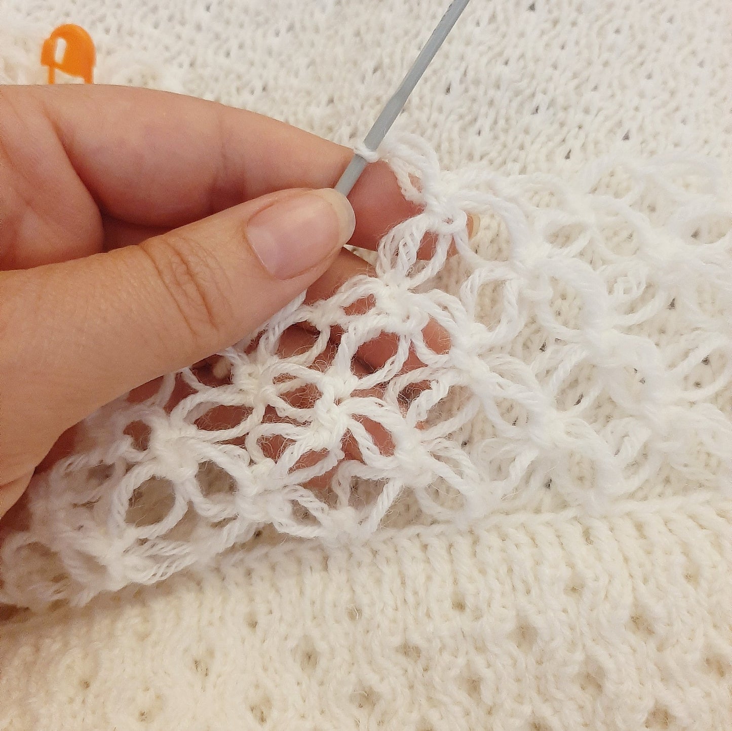 White honeycomb cover with witch stitch edge and blue ribbon