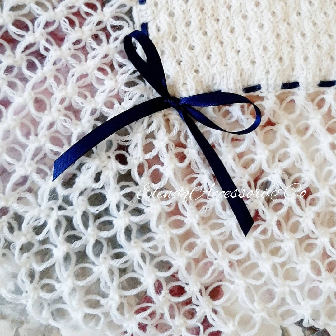 White honeycomb cover with witch stitch edge and blue ribbon